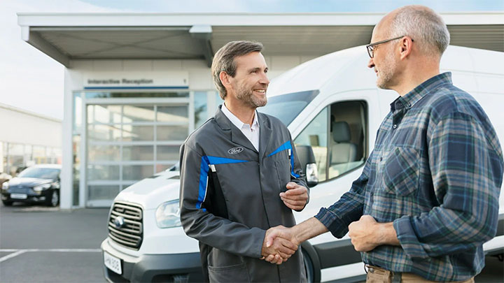 Ford technician and customer greeting each other