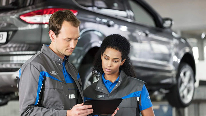 Ford technicians comparing notes