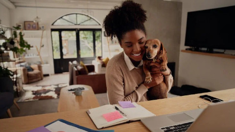 Woman at Desk with Dog