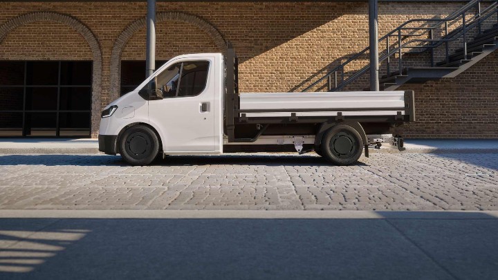 Side view of a Ford Transit City dropside van parked on a cobbled street