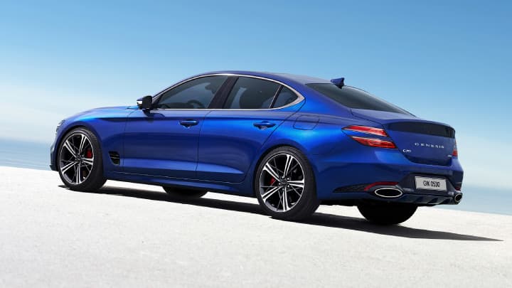 Blue Genesis G70 parked in a studio