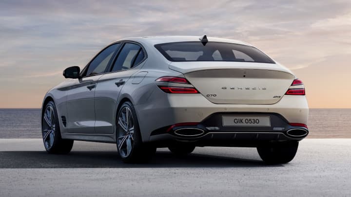 White Genesis G70 rear shot, parked in a studio