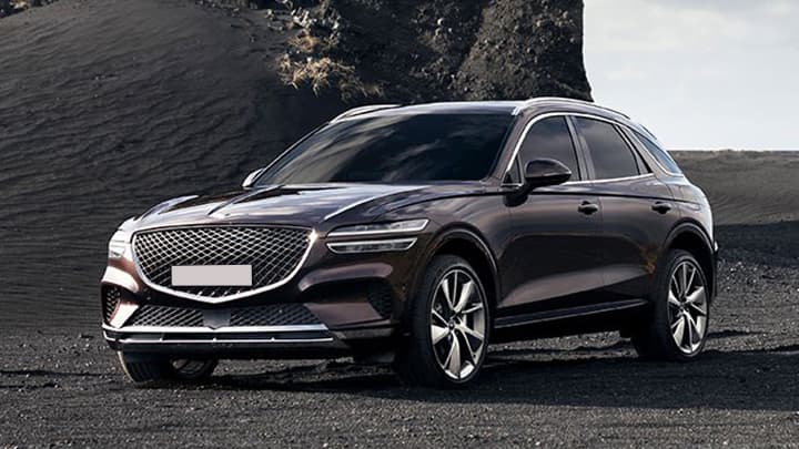 Grey Genesis GV70, parked on black sands of a mountain