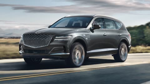 Grey Genesis GV80 driving on a country road