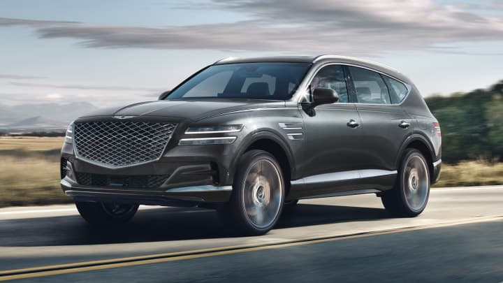 Grey Genesis GV80 driving on a country road