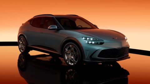 Blue Genesis GV60 parked in a studio with an orange background