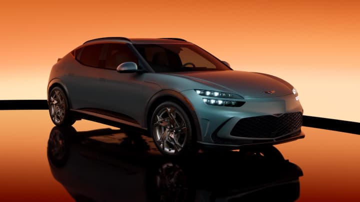 Blue Genesis GV60 parked in a studio with an orange background