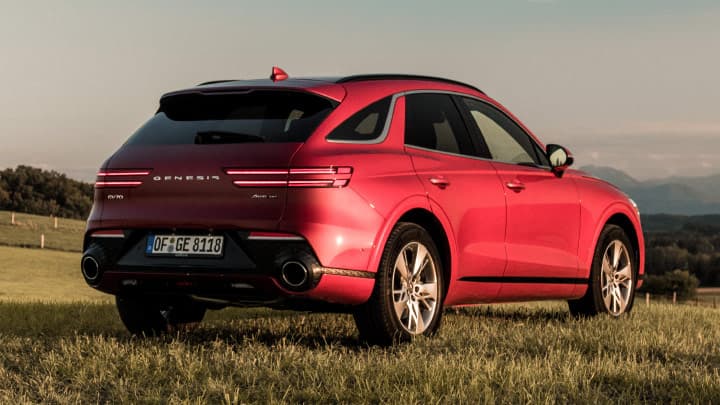 Red Genesis GV70 parked in a field