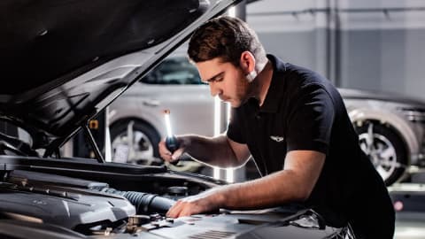 Genesis technician servicing a car in a workshop