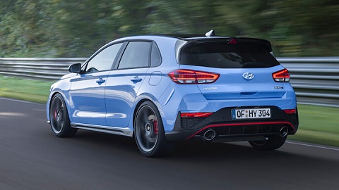 Blue Hyundai i30 N driving, rear