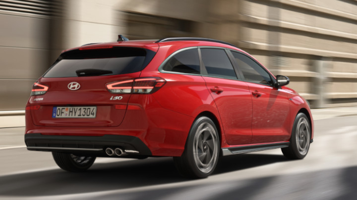 Hyundai i30 N Line Wagon in red driving rear angle