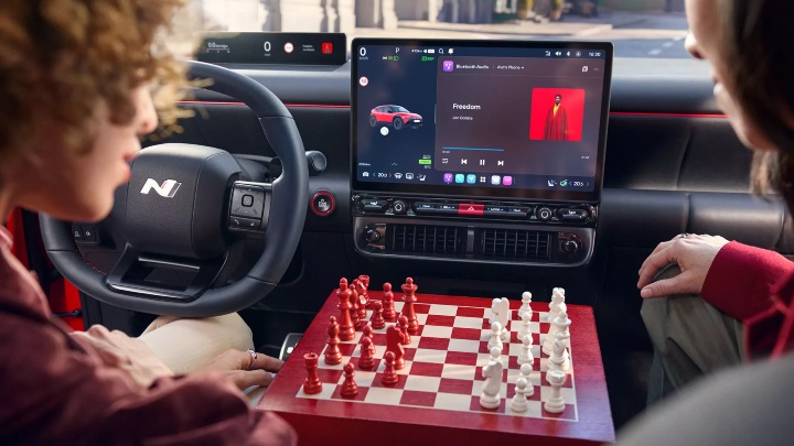 Hyundai IONIQ 3 interior with touchscreen display and chess board between seats