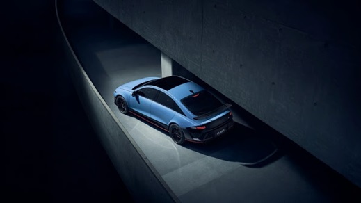 Aerial side view of the Hyundai IONIQ 6 N driving through a covered architectural space