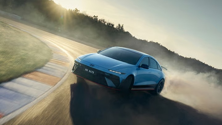 Hyundai IONIQ 6 N drifting on a race circuit, generating tyre smoke