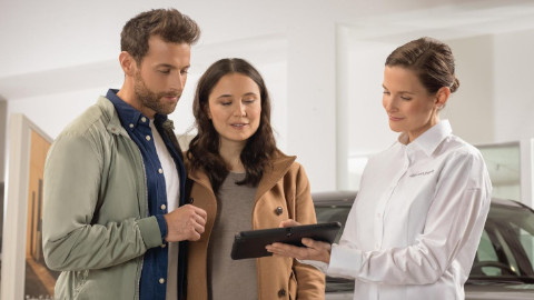 Assistant Showing Couple Tablet in Hyundai Dealership
