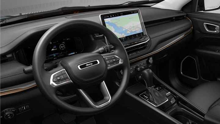 Close up of a Jeep Compass' steering wheel and infotainment system