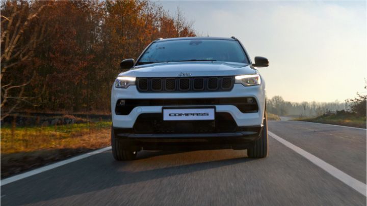White Jeep Compass 4xe driving on the motorway