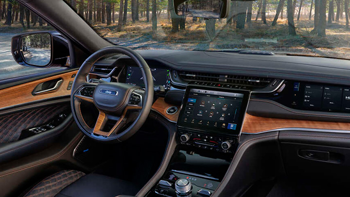 Close up of a Jeep Grand Cherokee's steering wheel and infotainment system