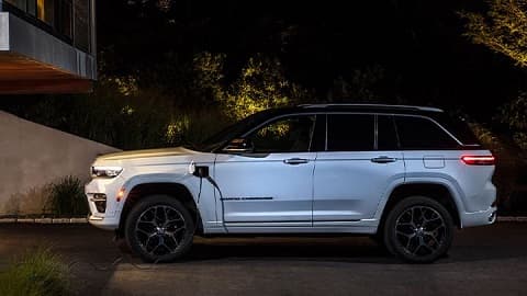 Side shot of a white Jeep Grand Cherokee that's on shot