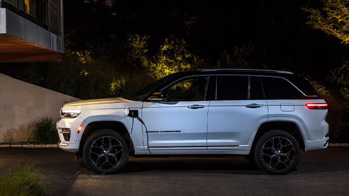 Side shot of a white Jeep Grand Cherokee that's on shot