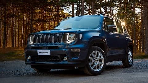 Front quarter shot of a blue Jeep Renegade, with a forest background