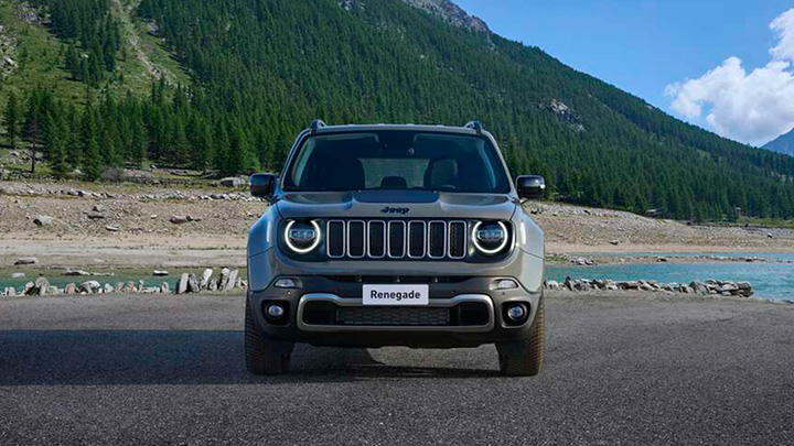 Front end shot of a grey Jeep Renegade with a mountain background