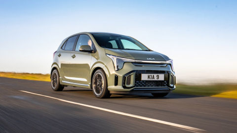 Green Kia Picanto driving on the motorway