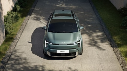 Green Kia Stonic compact SUV shown from an elevated front view on a modern driveway