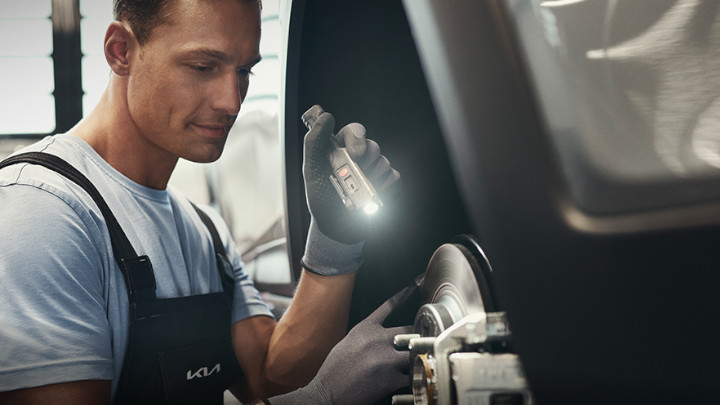 Technician Checking Car Brakes