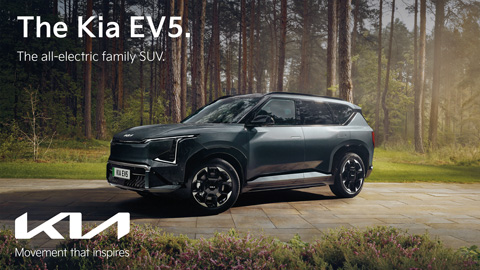 Dark Grey Kia EV5 Parked in Forest