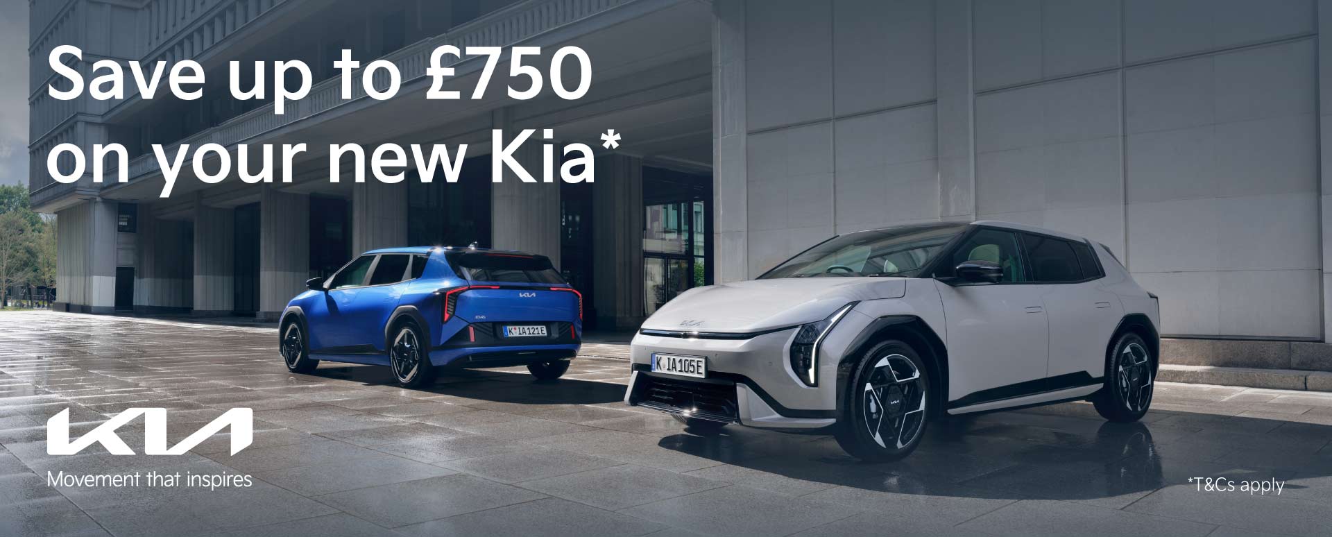 One White and One Blue Kia Parked Outside Modern Building With Promotional Messaging