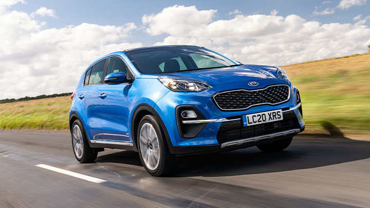 Blue Kia Sportage, driving