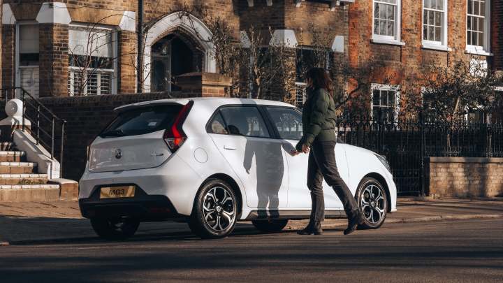 Side Shot Of Man Opening White MG3 Car Door