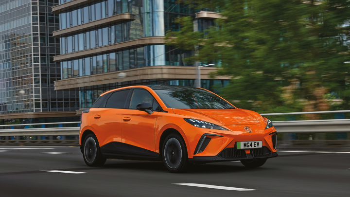Orange MG4 EV Driving On Road Front Shot
