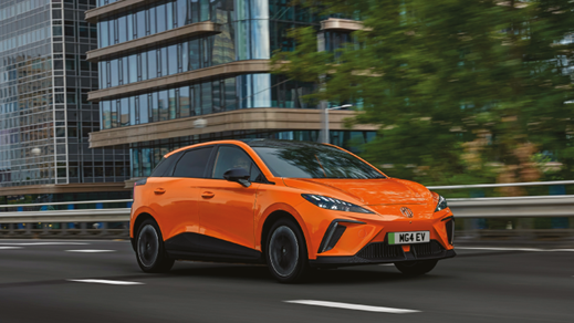 Orange MG4 EV Driving On Road Front Shot