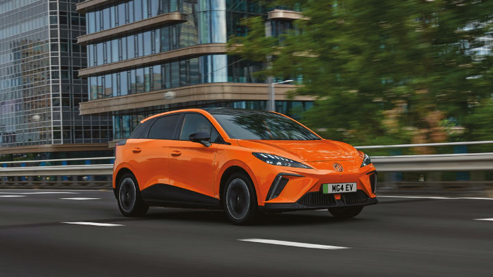 Orange MG4 EV Driving On Road Front Shot
