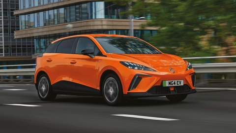 Orange MG4 EV Driving On Road Front Shot