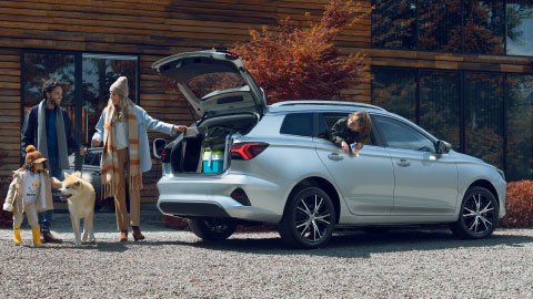 Family Loading Up The Boot Of Silver MG5 EV
