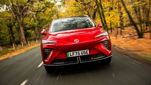 Red MGS6 EV Exterior Front Driving in Woodland