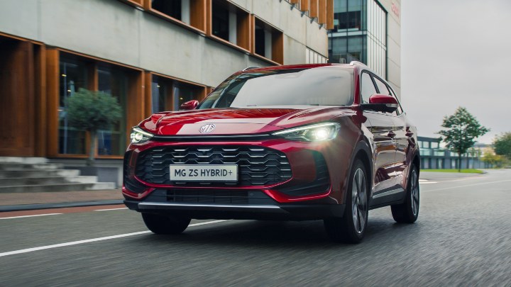 Red MG ZS Hybrid+ Exterior Front Driving in Urban Environment