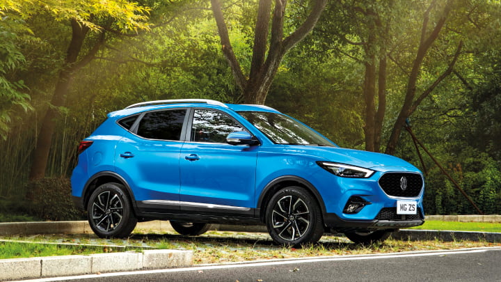 Blue MG ZS Parked On Grass From Side