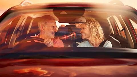 A through the front windscreen of a car shot of a couple staring at each other