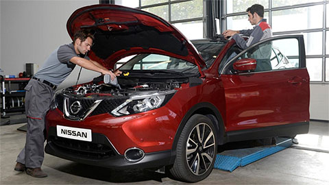 Two technicians servicing a Nissan Qashqai