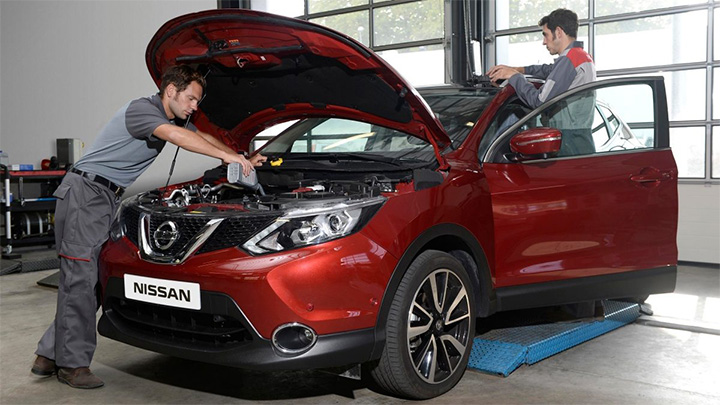 Two technicians servicing a Nissan Qashqai