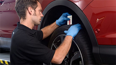 Nissan technician performing a vehicle health check