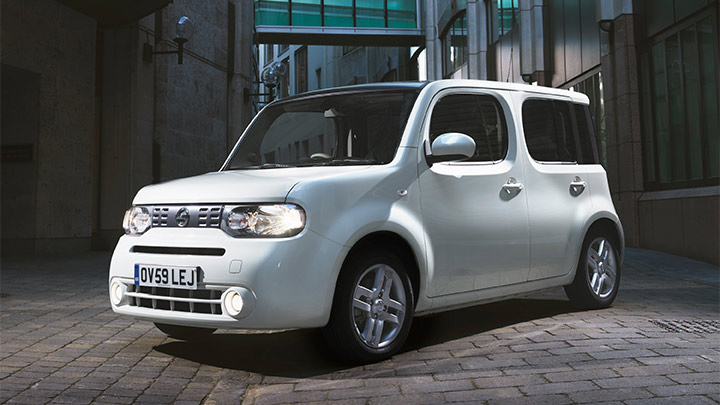 white nissan cube parked