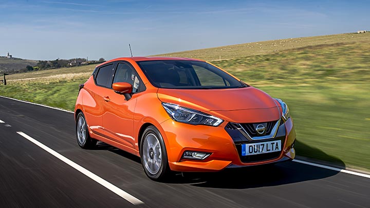 orange nissan micra driving, front quarter