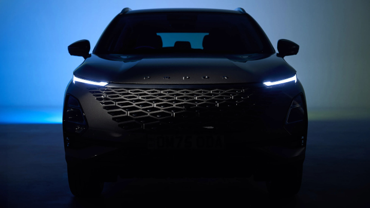 OMODA 5 in Dark Studio With Headlights On