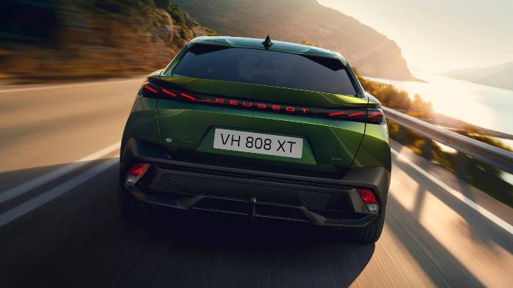 Green Peugeot e-408 Exterior Rear Driving Coastline