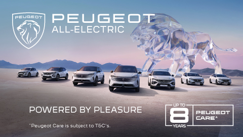 Fleet of Peugeot vehicles parked in front of mountains with a glass lion in the background